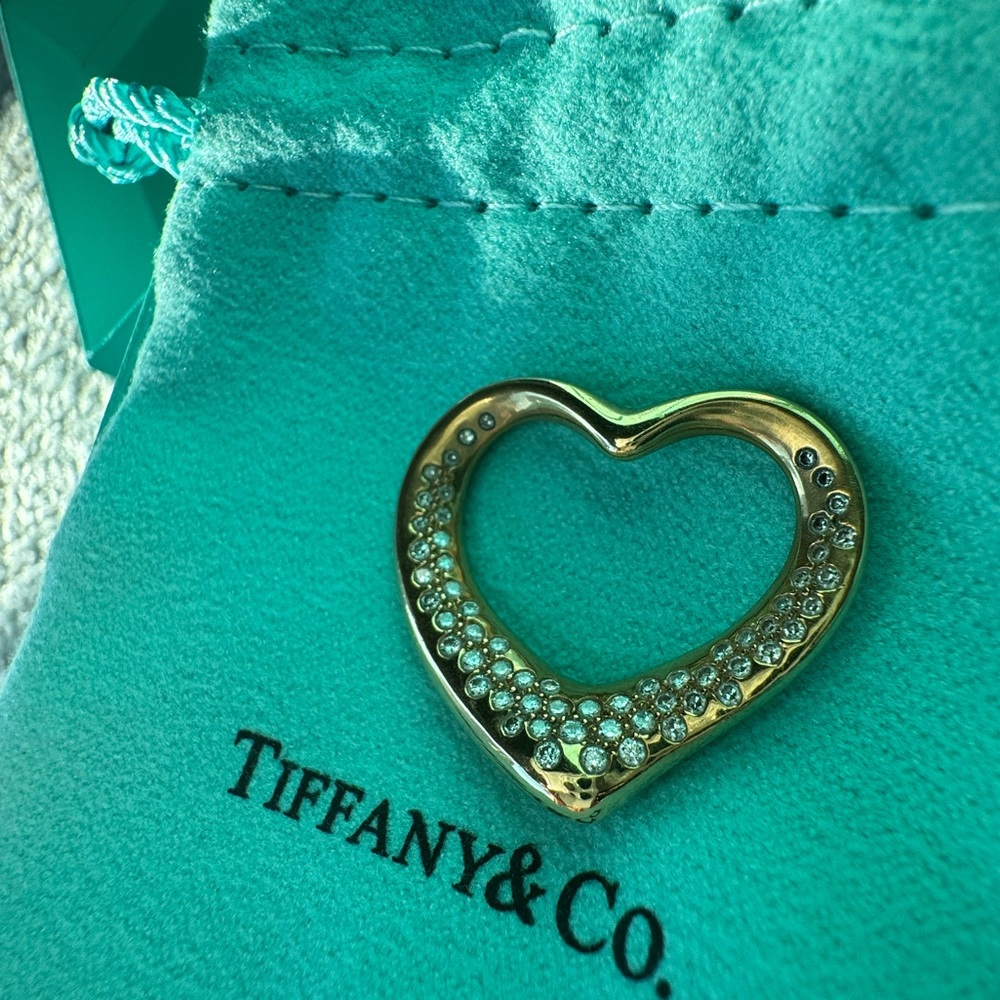 Authentic Tiffany & Co Heart pendant in 18K gold with 60 embedded diamonds.